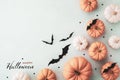 Halloween holiday background with party decorations of pumpkins and bats on blue top view. Greeting card Royalty Free Stock Photo