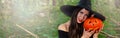 Young pretty woman in witch`s hat holding halloween pumpkin jack Royalty Free Stock Photo