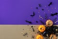 Halloween holiday card with party decorations of pumpkins, bats, spiders on gold violet background top view. Happy halloween Royalty Free Stock Photo
