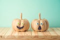 Halloween holiday concept with cute funny pumpkin decor on wooden table Royalty Free Stock Photo