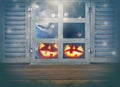 Halloween holiday concept. Empty rustic table in front of haunted night sky background and old window. Ready for product display m Royalty Free Stock Photo