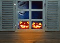 Halloween holiday concept. Empty rustic table in front of haunted night sky background and old window. Ready for product display m Royalty Free Stock Photo