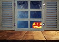 Halloween holiday concept. Empty rustic table in front of haunted night sky background and old window. Ready for product display m Royalty Free Stock Photo