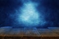 Halloween holiday concept. Empty rustic table in front of scary and misty night sky background. Ready for product display montage.