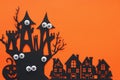 Halloween holiday concept. haunted witch house over orange background. Top view, flat lay.