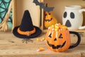 Halloween holiday concept with jack o lantern cuo and candy corn on wooden table