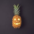 Halloween holiday concept with jack o lantern pineapple