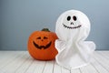 Halloween holiday concept with jack pumpkin and ghost decor on wooden table