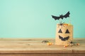 Halloween holiday concept with party gift paper bag decor and candy corn on wooden table