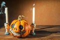 Halloween holiday concept. Pumpkin with a face. Burning and extinguished candles. Background for text with pumpkin and smoke. Hall Royalty Free Stock Photo