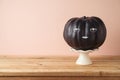 Halloween holiday creative concept with cute funny black pumpkin decor on wooden table Royalty Free Stock Photo