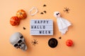 Halloween holiday decorations with lightbox with words Happy Halloween flat lay on orange background