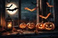 halloween holiday decorations, scary jack o lantern pumpkins and candles on a windowsill, flying bats outside the window Royalty Free Stock Photo