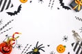 Halloween holiday party background with gifts, decorations and cocktail straw on white backdrop Royalty Free Stock Photo