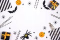 Halloween holiday party background with gifts, decorations and cocktail straw on white backdrop Royalty Free Stock Photo