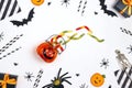 Halloween holiday party background with gummy worm, gifts and decorations on white backdrop Royalty Free Stock Photo