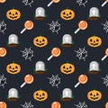 Halloween holiday pattern grave in cemetery, orange pumpkin, spider and cobweb, sweet candy lollipop, dark background Royalty Free Stock Photo