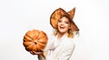 Halloween holiday. Smiling woman in witch hat with big pumpkin. Trick or treat. Happy Halloween. Halloween party girl Royalty Free Stock Photo