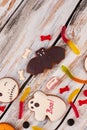 Halloween holiday sweets on wooden background.