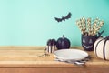 Halloween holiday table setting with glitter black pumpkin, party chalkboard cup and candy Royalty Free Stock Photo