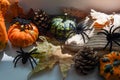 Halloween home decor on the window sill, pumpkins and spiders on white background