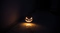 Halloween horror concept with glowing pumpkin. Halloween evil pumkins smilin faces in dark