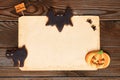 Halloween invitation over wooden background