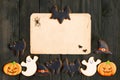 Halloween invitation over wooden background