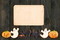 Halloween invitation over wooden background