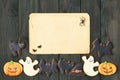 Halloween invitation over wooden background