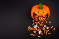 Halloween jack o lantern with spilling candy, above view on a black background Royalty Free Stock Photo