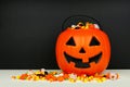 Halloween Jack o Lantern bucket filled with candy against a black background Royalty Free Stock Photo