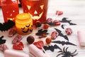 Halloween Jack o Lantern, candle light, holiday candy, bats, spiders, skulls on white rustic wooden background. Trick or treat. H Royalty Free Stock Photo