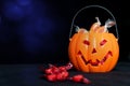 Halloween Jack o Lantern candy collector full of candy and some Royalty Free Stock Photo