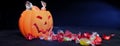 Halloween Jack o Lantern candy collector full of candy and some Royalty Free Stock Photo