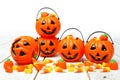 Halloween Jack o Lantern candy holders on white wood Royalty Free Stock Photo