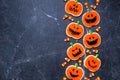 Halloween jack o lantern cookie side border on a dark stone background Royalty Free Stock Photo