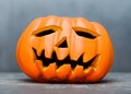 A Halloween Jack-o\'-lantern isolated on a gray background.