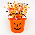 Halloween Jack o Lantern pail with spilling candy, top view on a white background Royalty Free Stock Photo