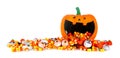 Halloween jack o lantern wide mouth bowl with spilling candy border isolated on white Royalty Free Stock Photo