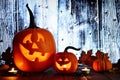 Halloween Jack o Lanterns, night scene against wood Royalty Free Stock Photo