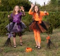 Halloween kid girls costume witches scaring gesture in outdoor. Royalty Free Stock Photo