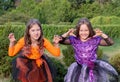 Halloween kid girls costume witches scaring gesture in outdoor. Royalty Free Stock Photo