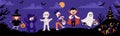 Halloween Kids Costume Party. Kids in various costumes for the holiday. Night sky background, a silhouette of a castle Royalty Free Stock Photo