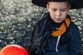 Halloween kids. Cute little boy sad in Halloween, child in witch hat with orange Jack O Lantern balloon