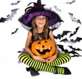 Halloween kids, Happy scary girl dressed up in halloween costume of witch, sorcerer for pumpkin patch and halloween party Royalty Free Stock Photo