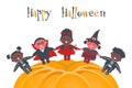 Halloween kids party template. Children in Halloween costumes around halloween pumpkin Royalty Free Stock Photo