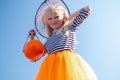 Halloween kids. Portrait Laughing girl in witch costume hat with pumpkin candy bucket on street Royalty Free Stock Photo