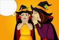 Halloween. The little girl`s mother whispers a secret in her ear