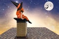 Halloween.Little girl in a witch costume sitting on the roof and looks at the sky. Royalty Free Stock Photo